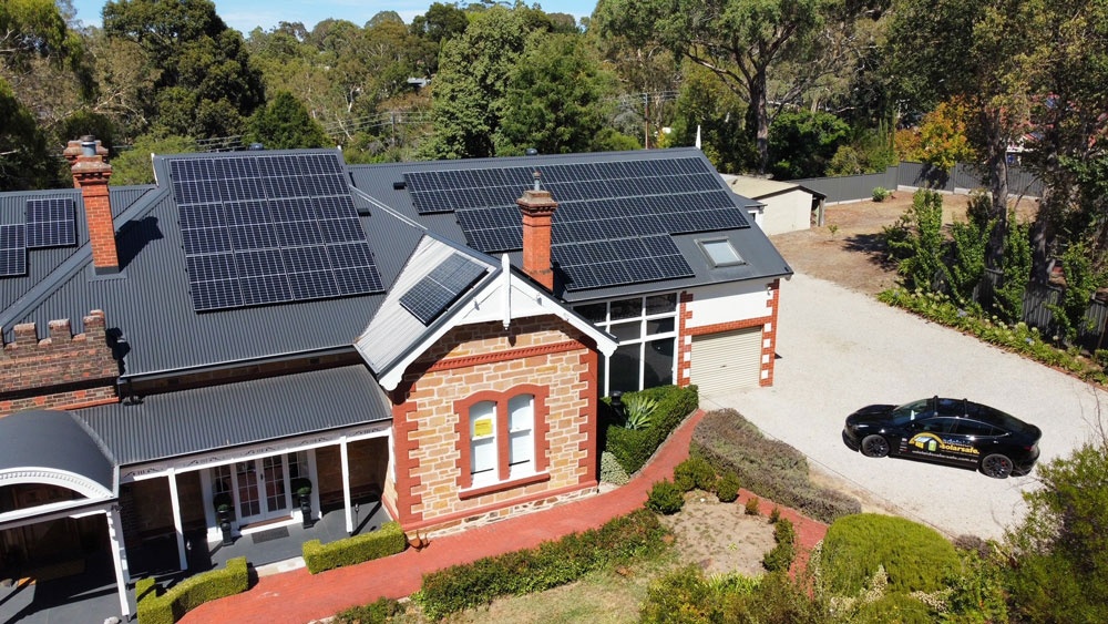 Aerial view of solar panels across a residential character-property roof