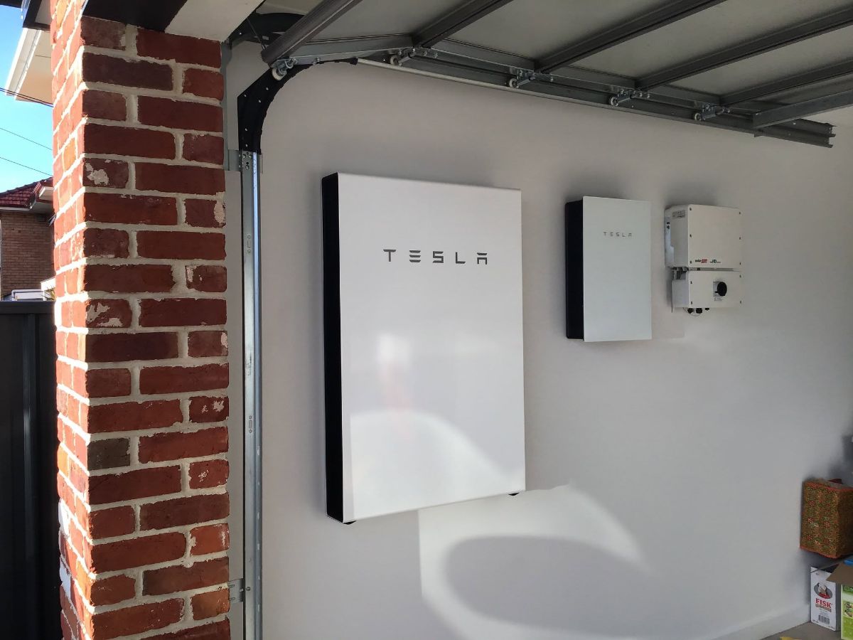 Tesla Powerwall home battery installed on a garage wall